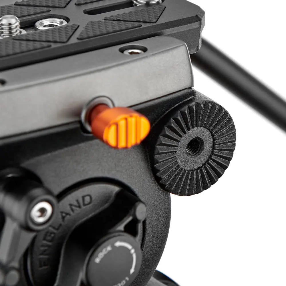 Close-up of a camera mount with an orange button and 'Finnland' branding on a white background