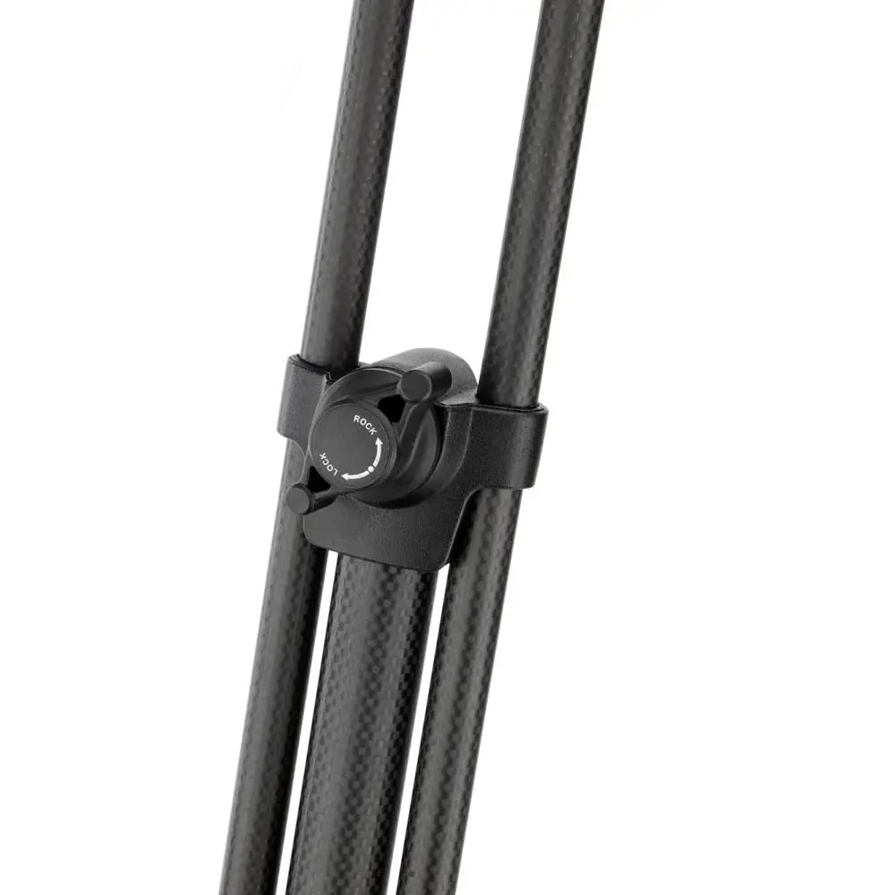 Black carbon fiber tripod with quick release plate on a white background