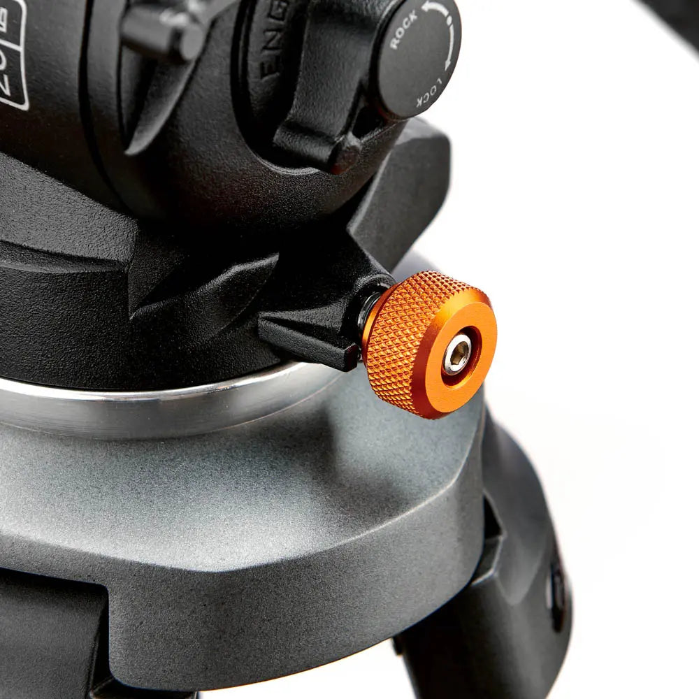 Close-up of a mechanical component with an orange knob on a white background