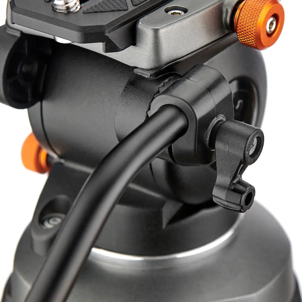 Close-up of a camera stabilizer with black and orange components on a white background