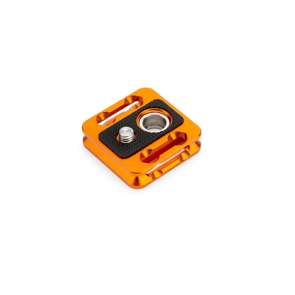 Orange metal camera accessory on a white background