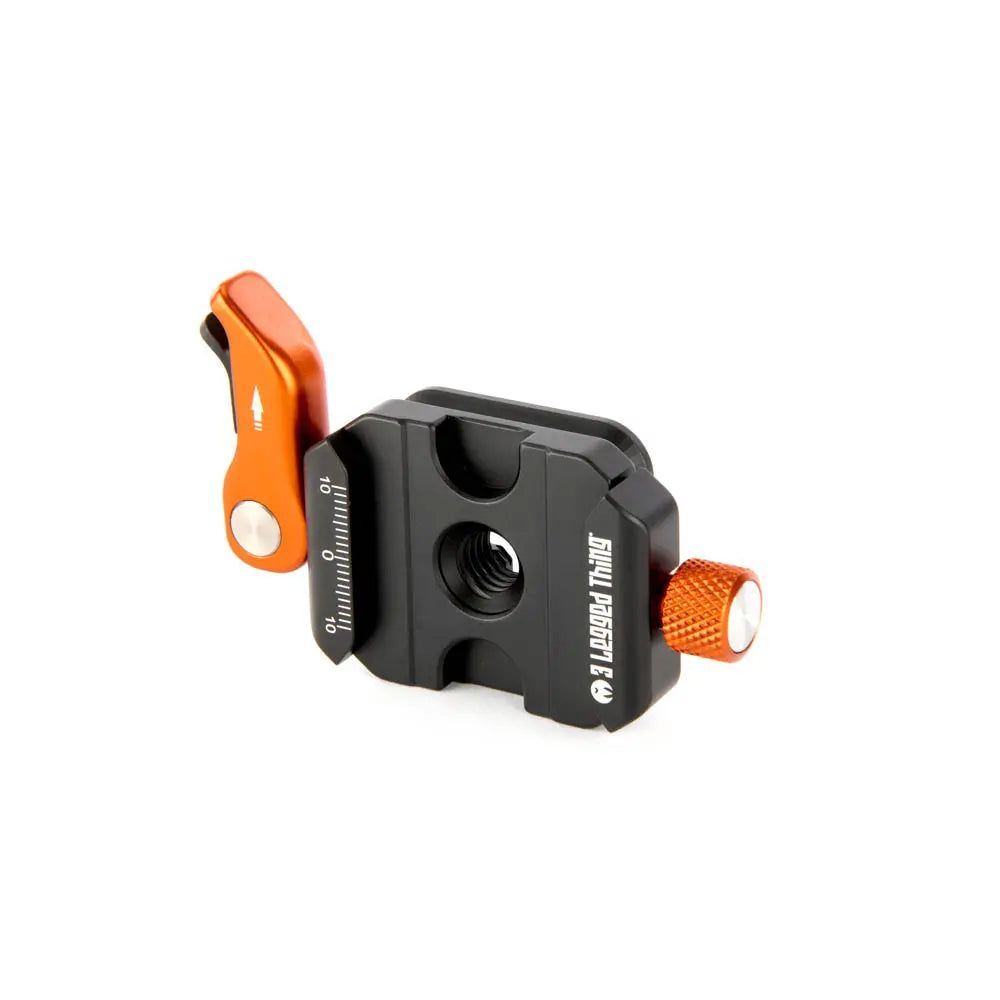 Camera quick release plate with orange and black design on a white background