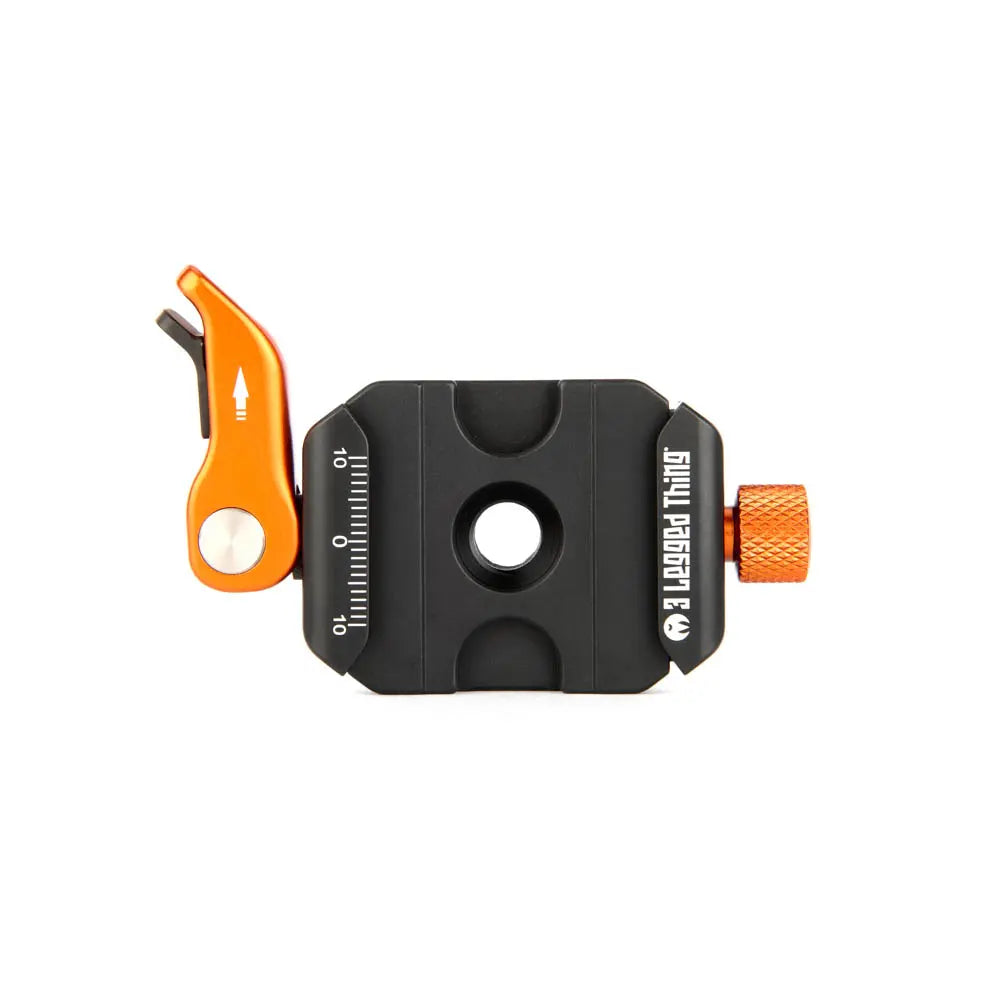 Black and orange camera quick release plate on a white background