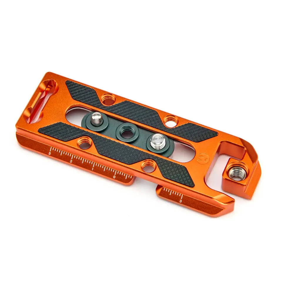 Orange metal tool with black textured surface on a white background