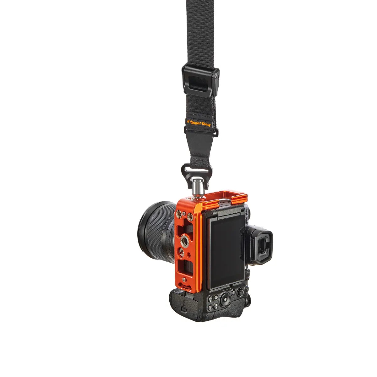 Camera with an orange and black body and strap on a white background