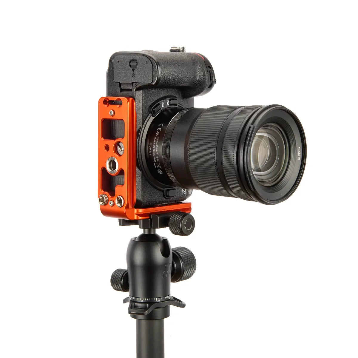 Camera with an orange and black attachment on a white background