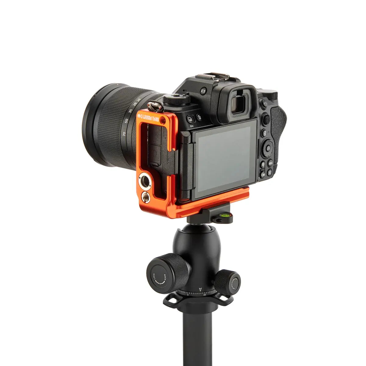 Camera mounted on a tripod with an orange and black protective cover on a white background