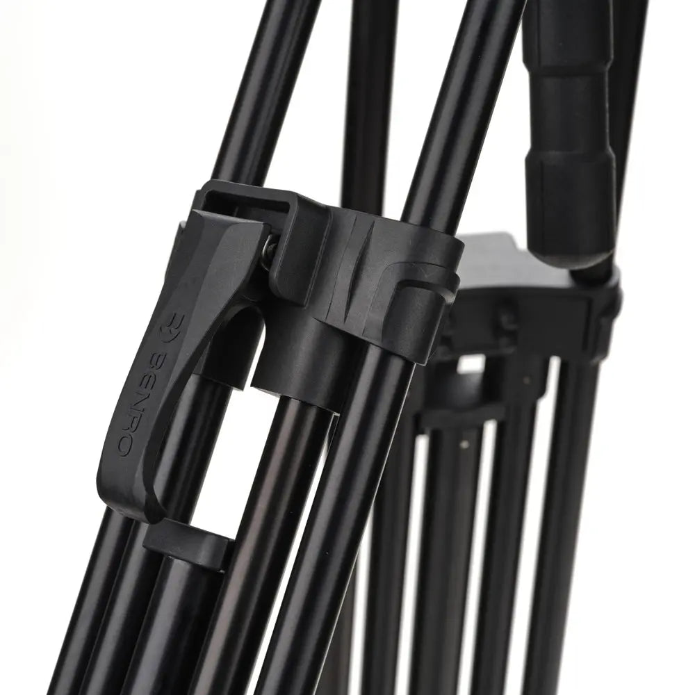 Close-up of a black tripod with a white background