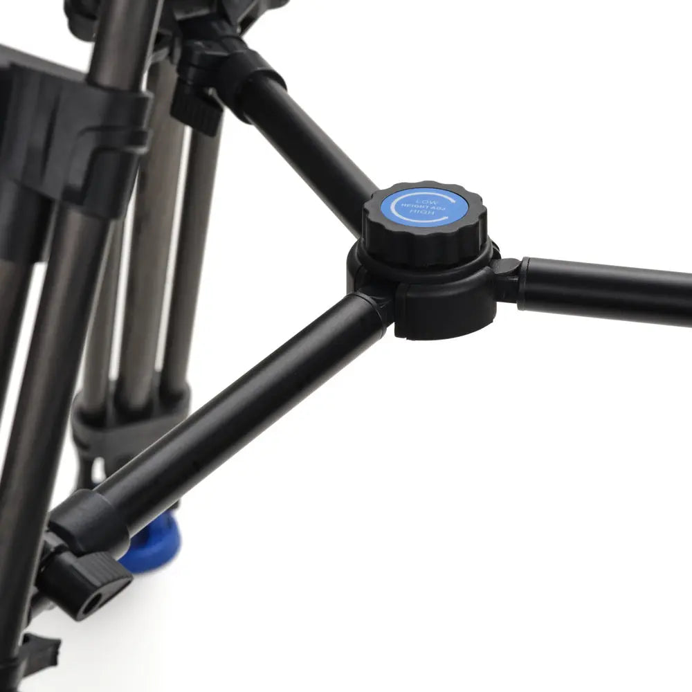Close-up of a black tripod with blue connectors on a white background