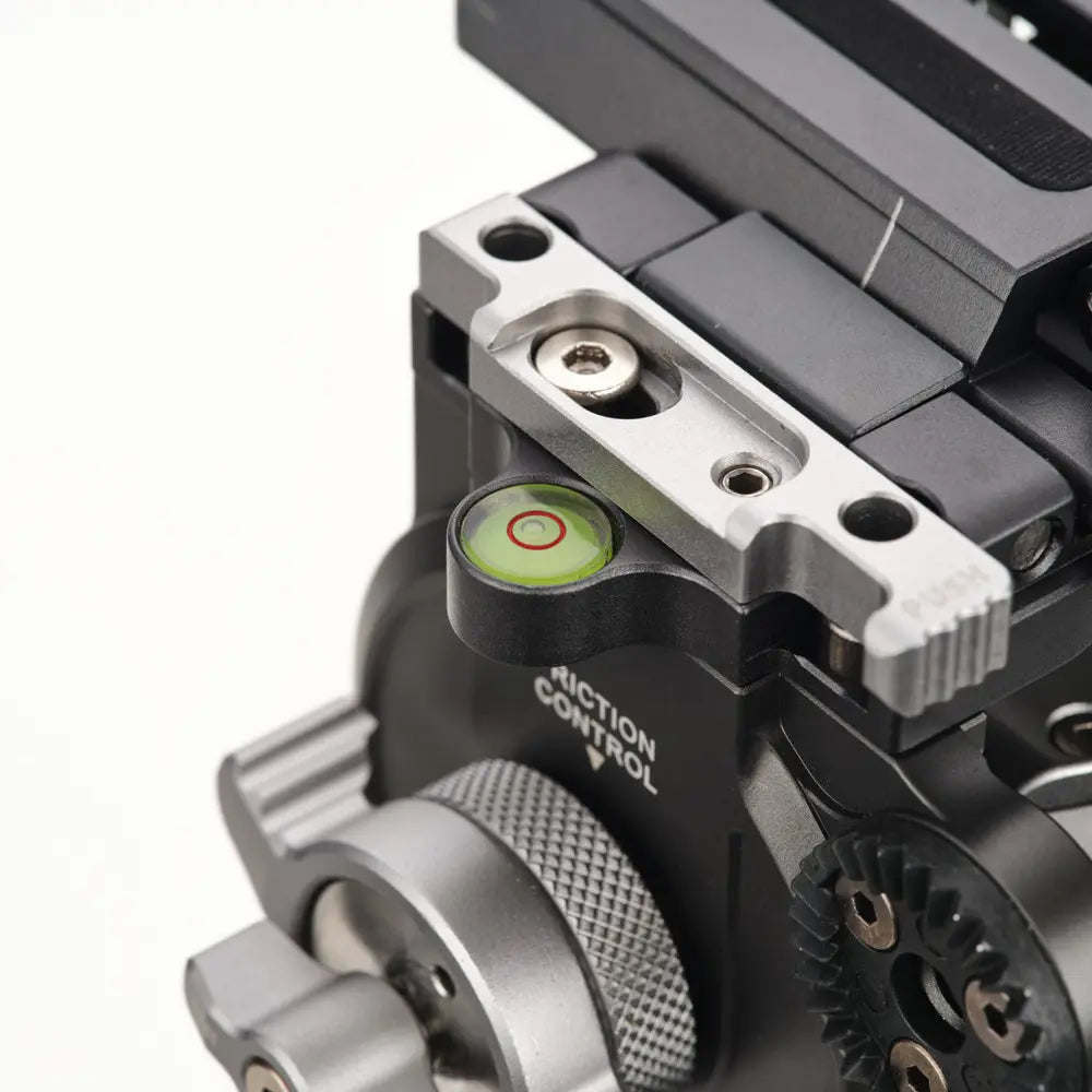 Close-up of a mechanical device with gears and control knobs on a white background
