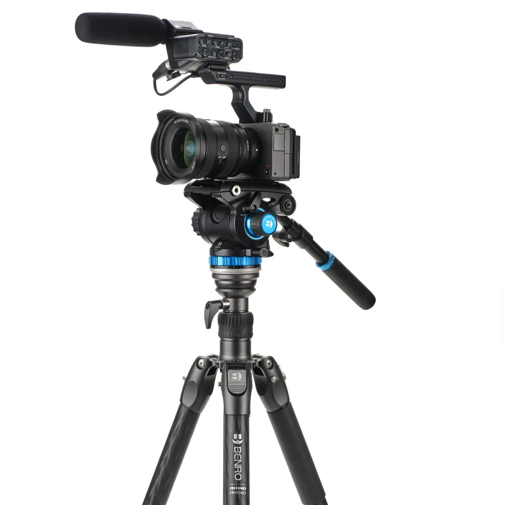 Camera on a tripod with microphone on a white background