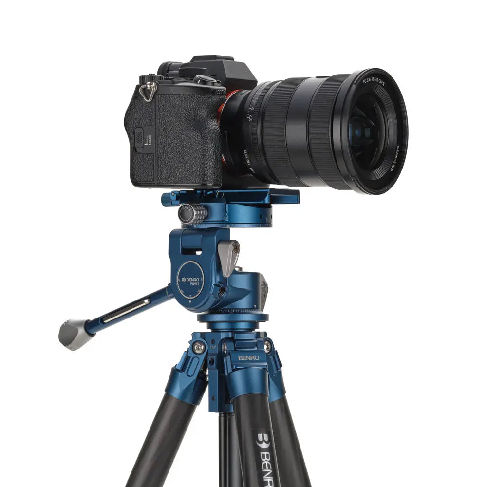 Camera on a blue Benro tripod with a white background