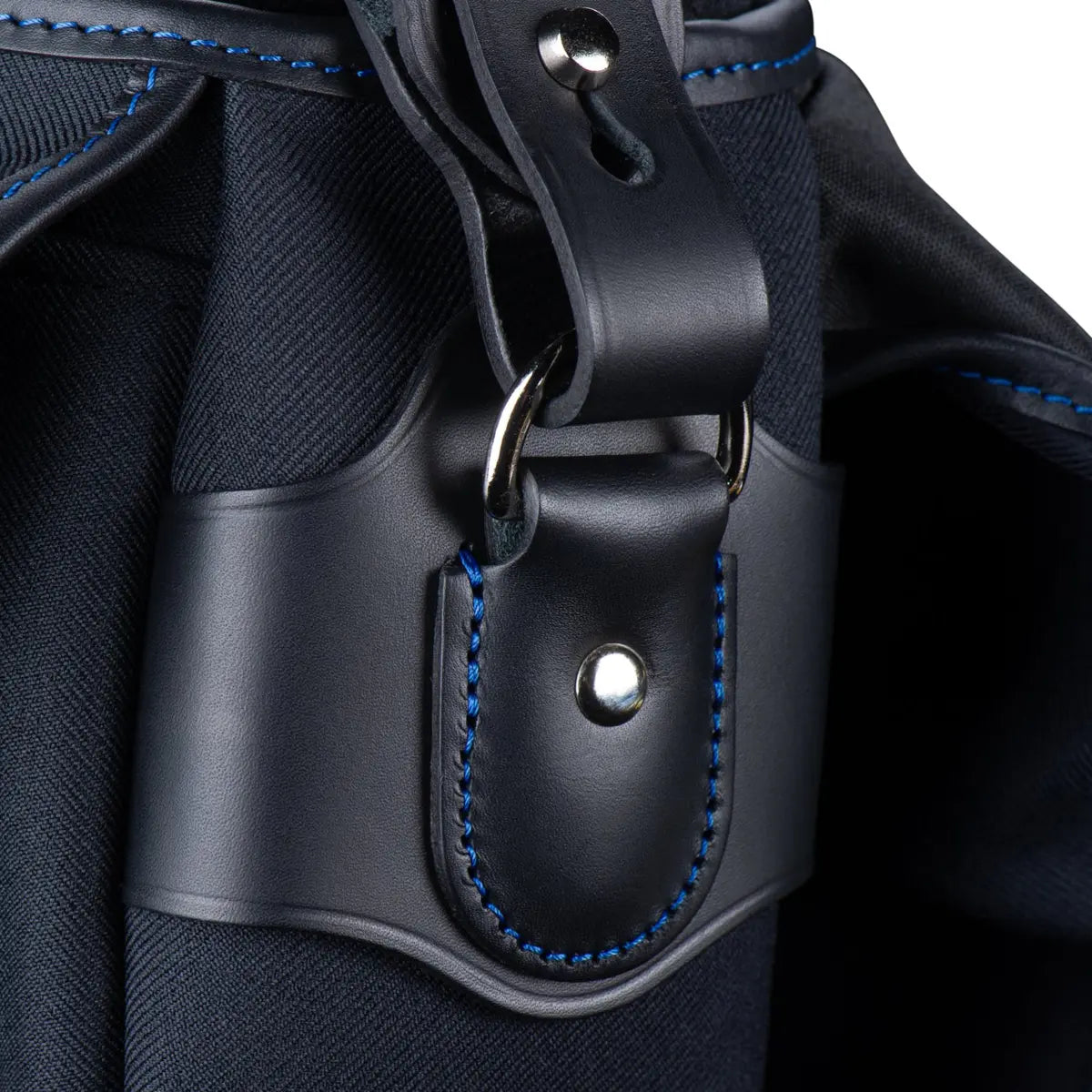 Close-up of a black leather strap with blue stitching on a dark background