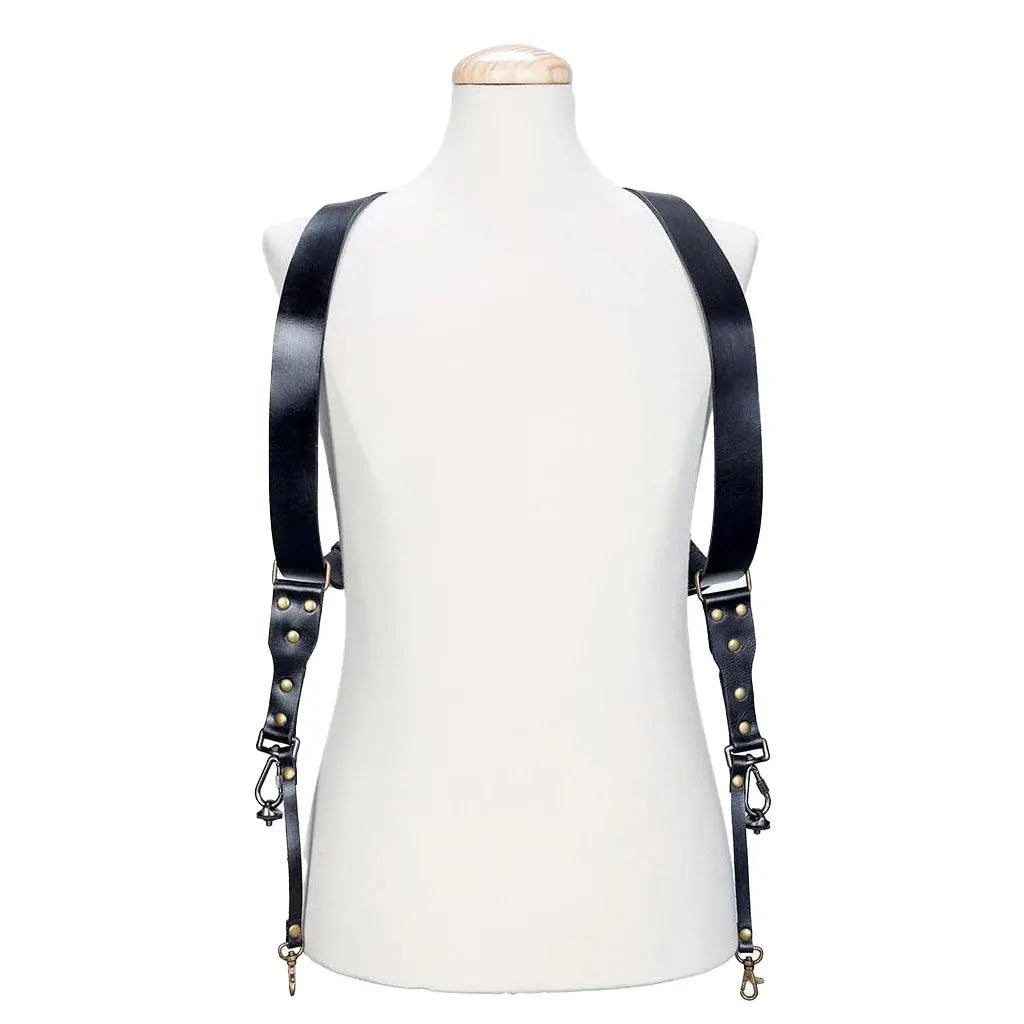 Black leather suspenders on a mannequin against a white background