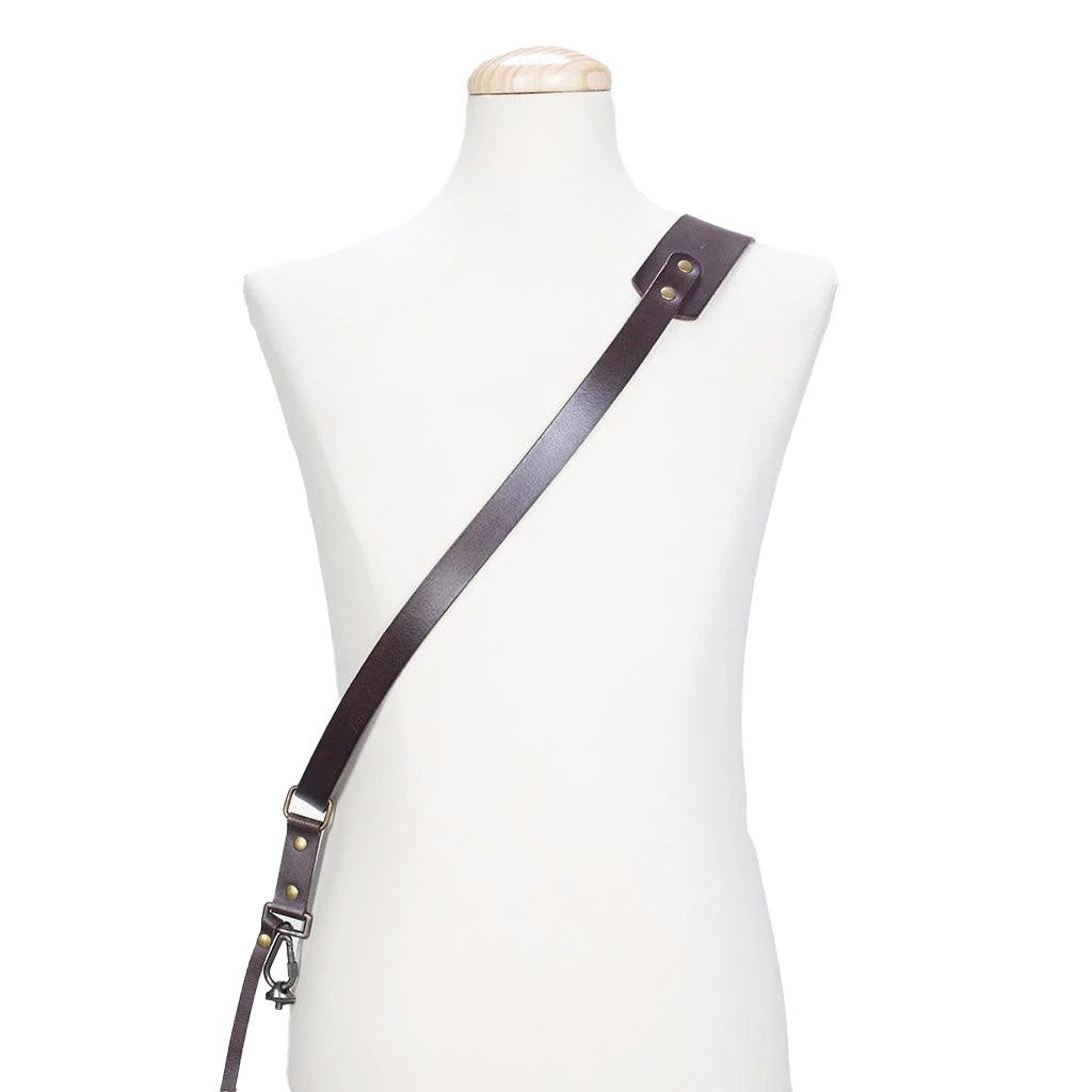 Brown leather strap with metal hardware on a mannequin against a white background