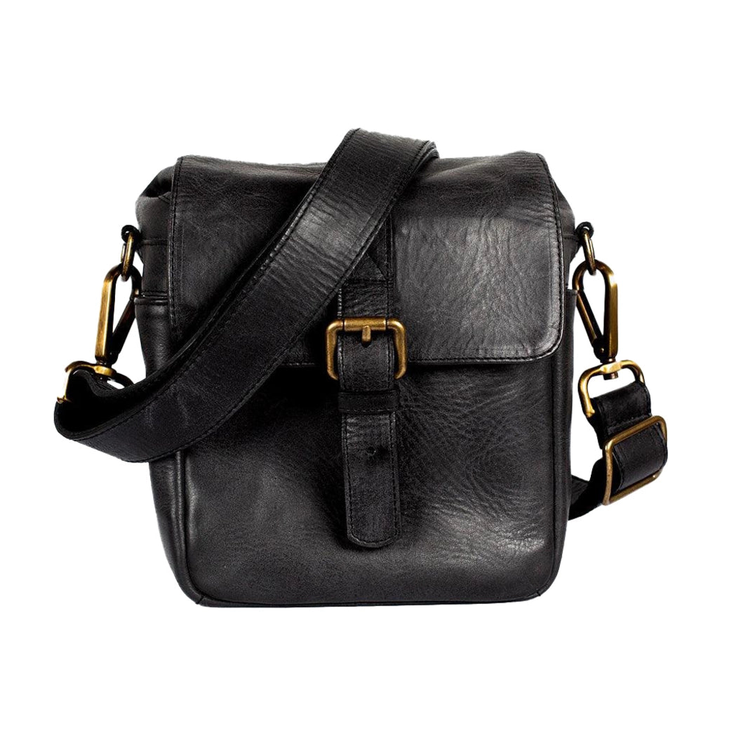 Black leather satchel bag with gold buckles on a white background