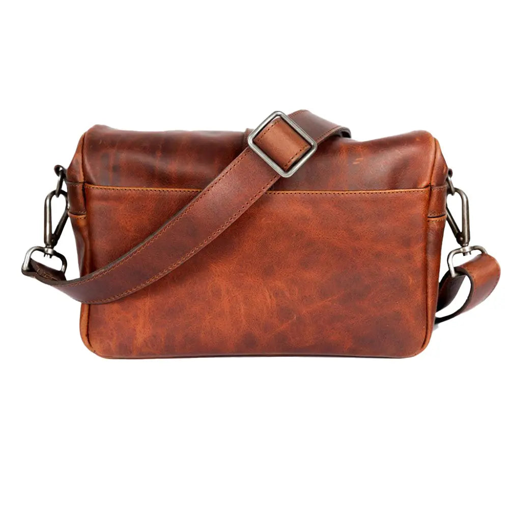 Brown leather messenger bag with a strap on a white background
