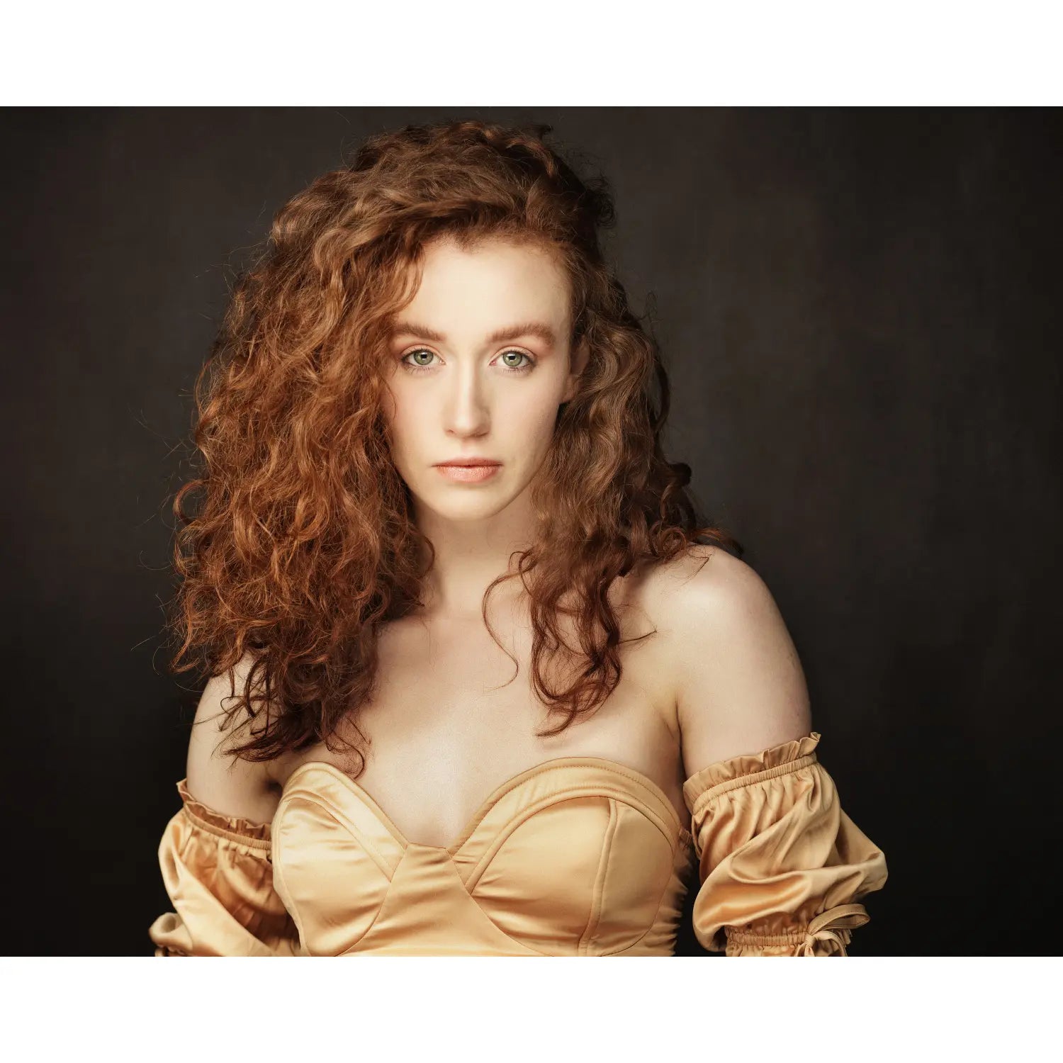 Woman in a beige dress with a dark background