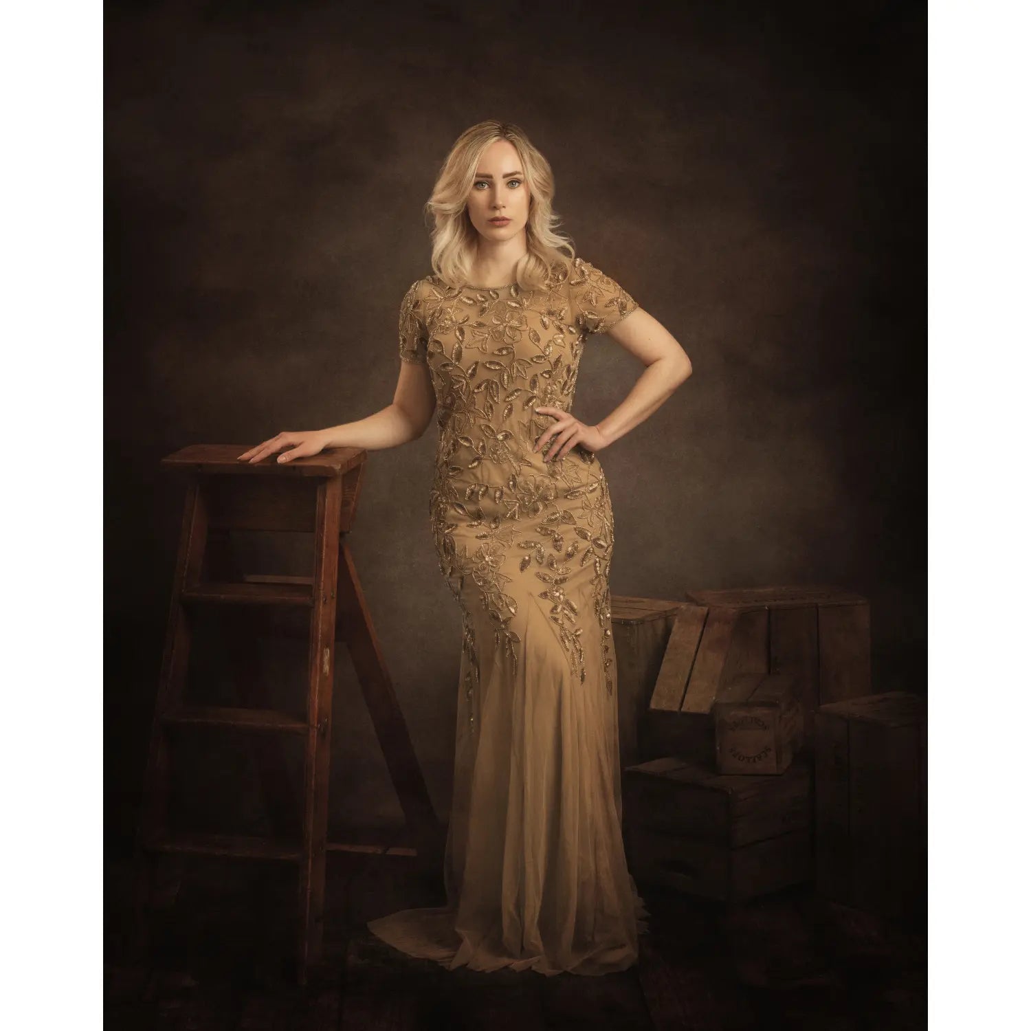 Woman in a detailed dress standing next to a wooden ladder against a dark background