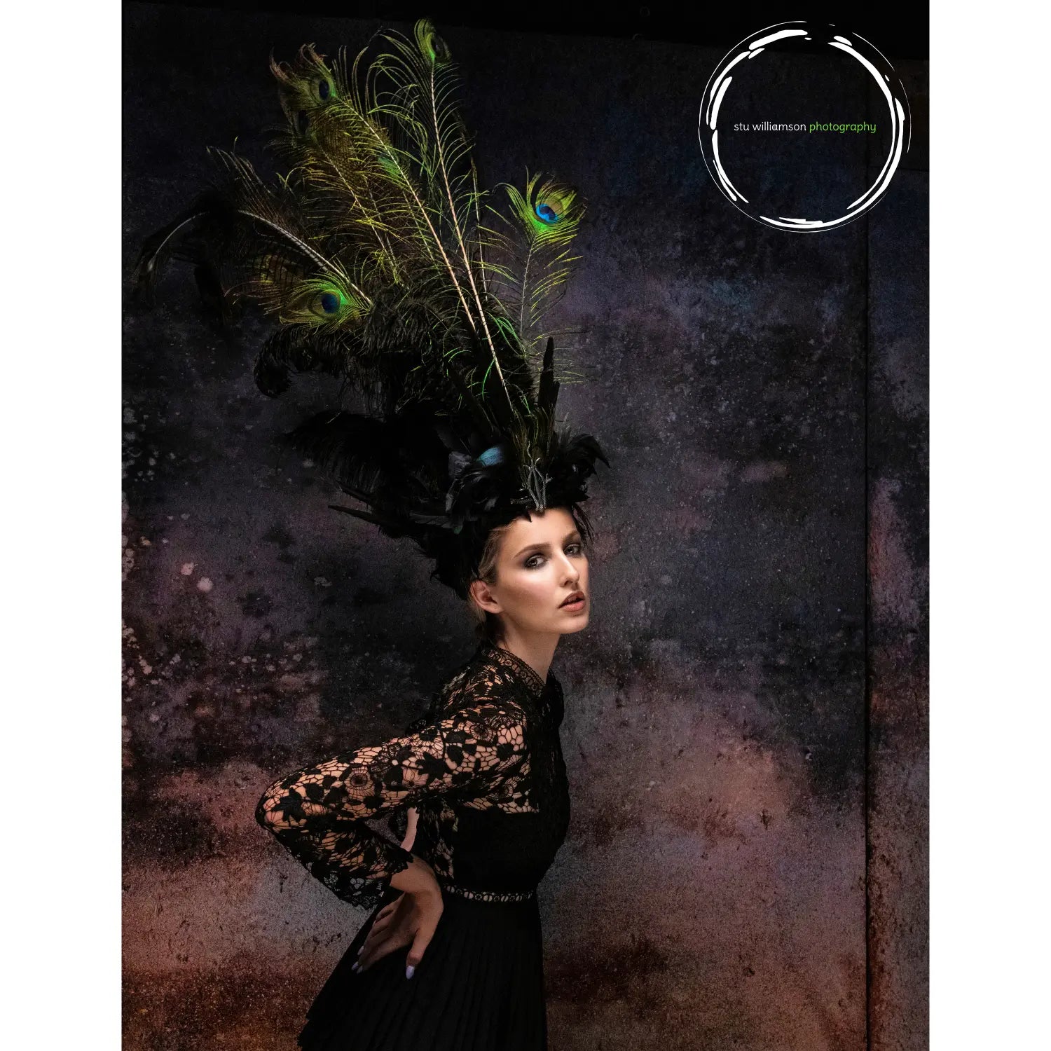 Woman wearing a peacock feather headdress against a dark, textured background