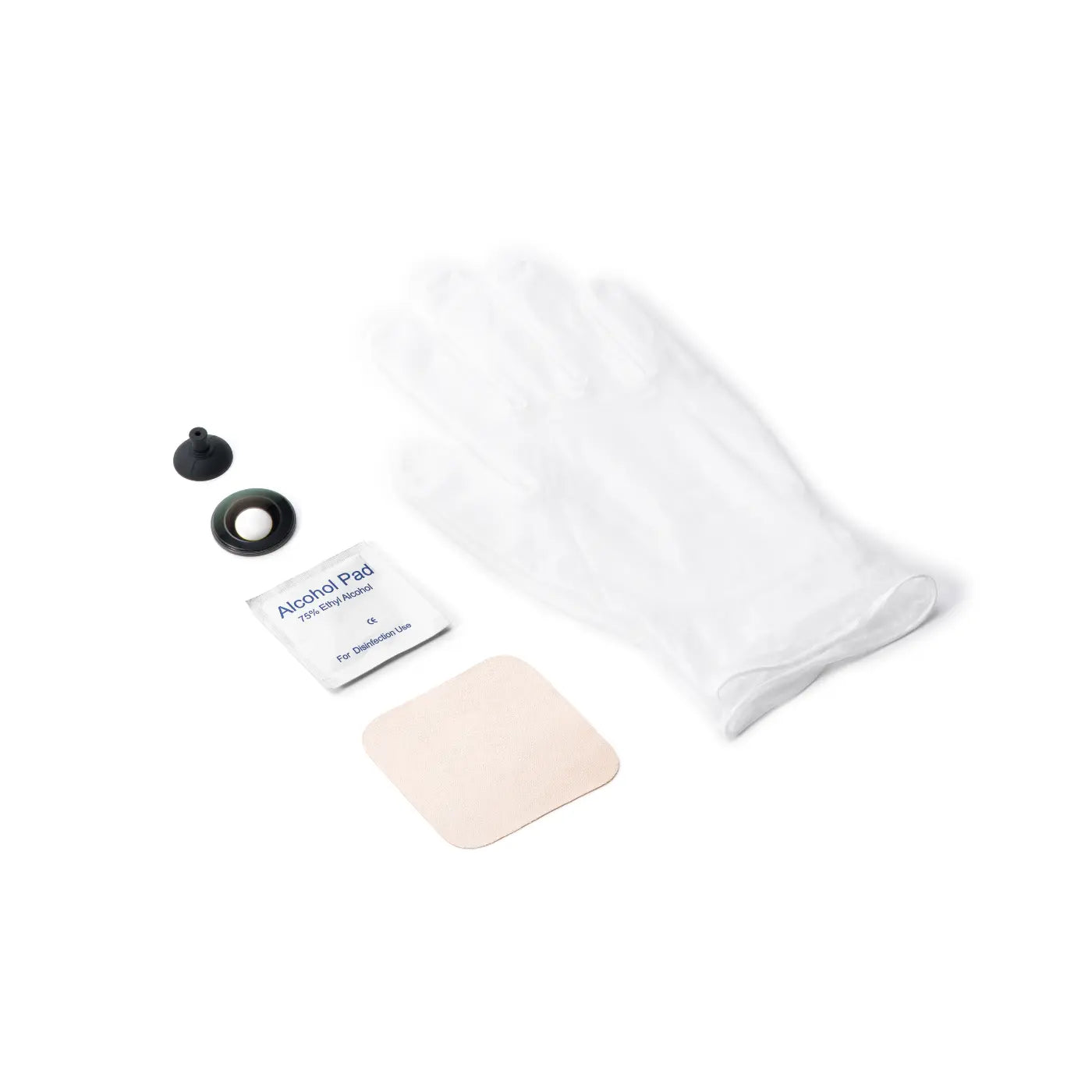 White cotton pad, alcohol pad, and black applicator on a white background