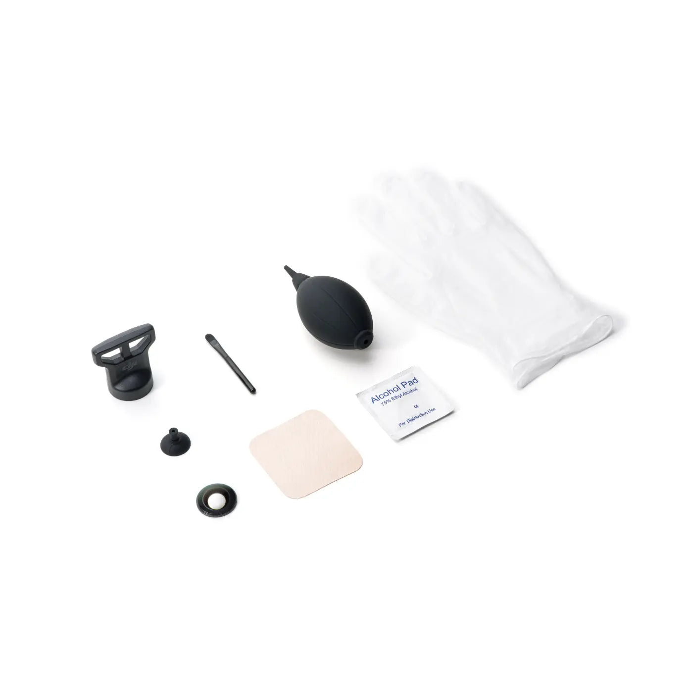 White cotton pad, alcohol pad, and black applicator on a white background