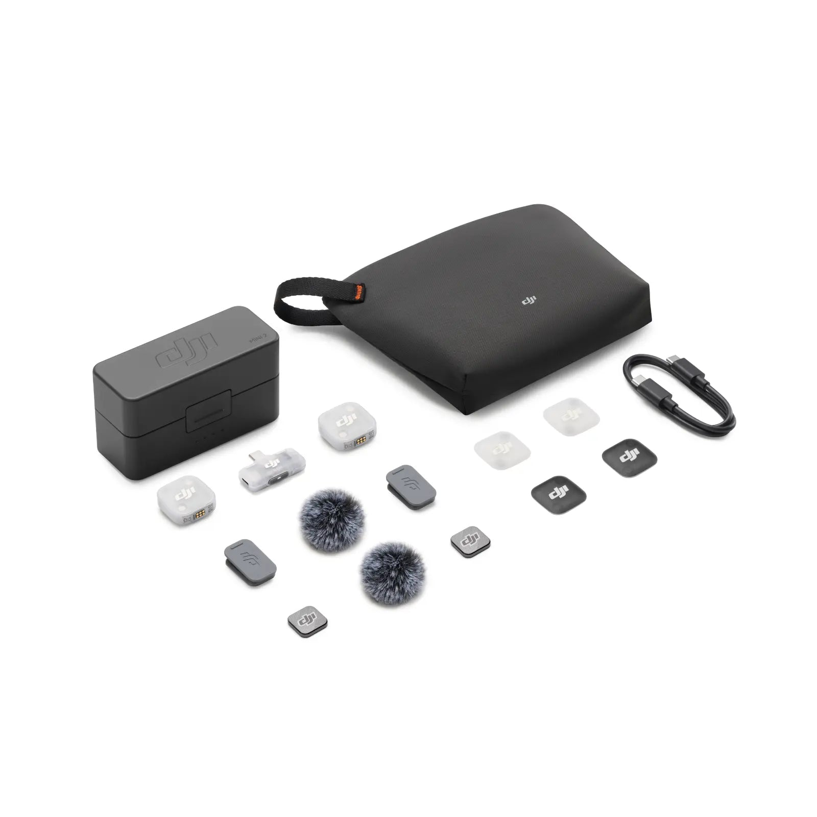 Collection of black electronic accessories including a case, battery, and various small components on a white background.
