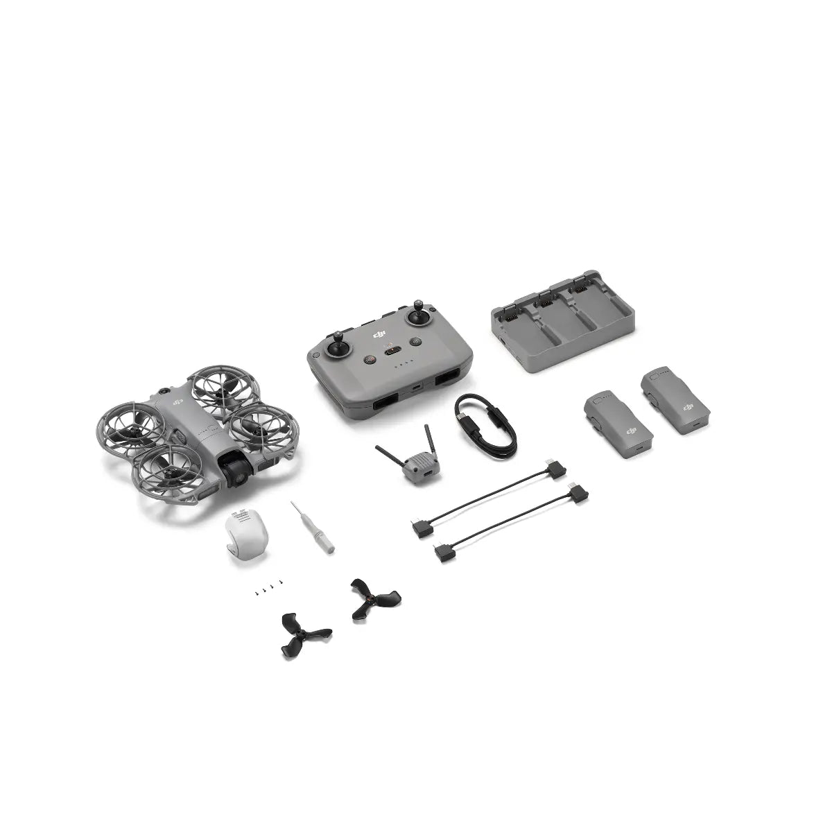 Collection of drone parts including a drone, remote control, and accessories on a white background