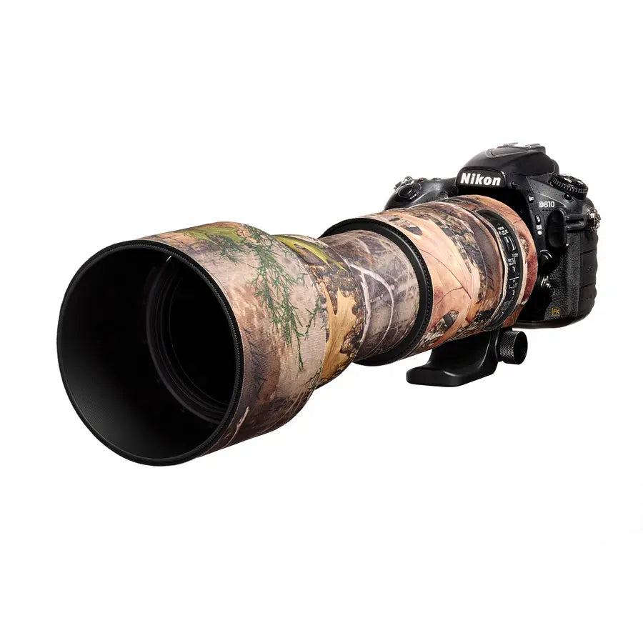 Nikon camera with a large camouflage lens on a white background