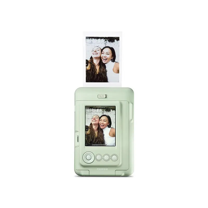 Mint green photo printer with printed photos of two women on a white background