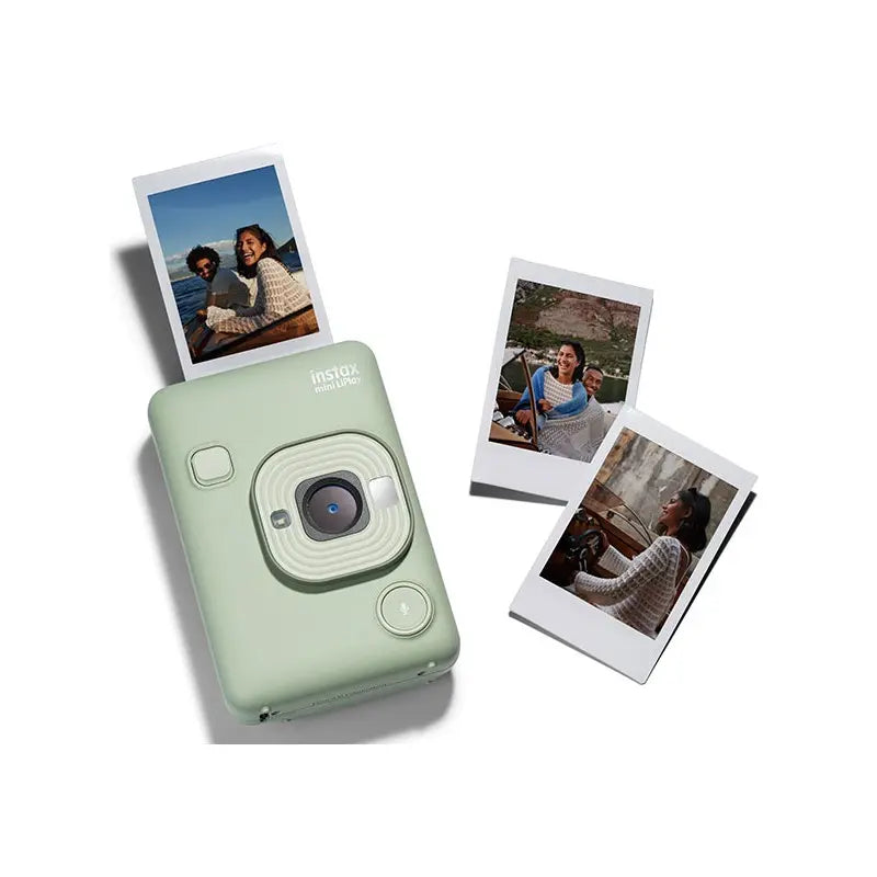 Mint green instant camera with printed photos on a white background