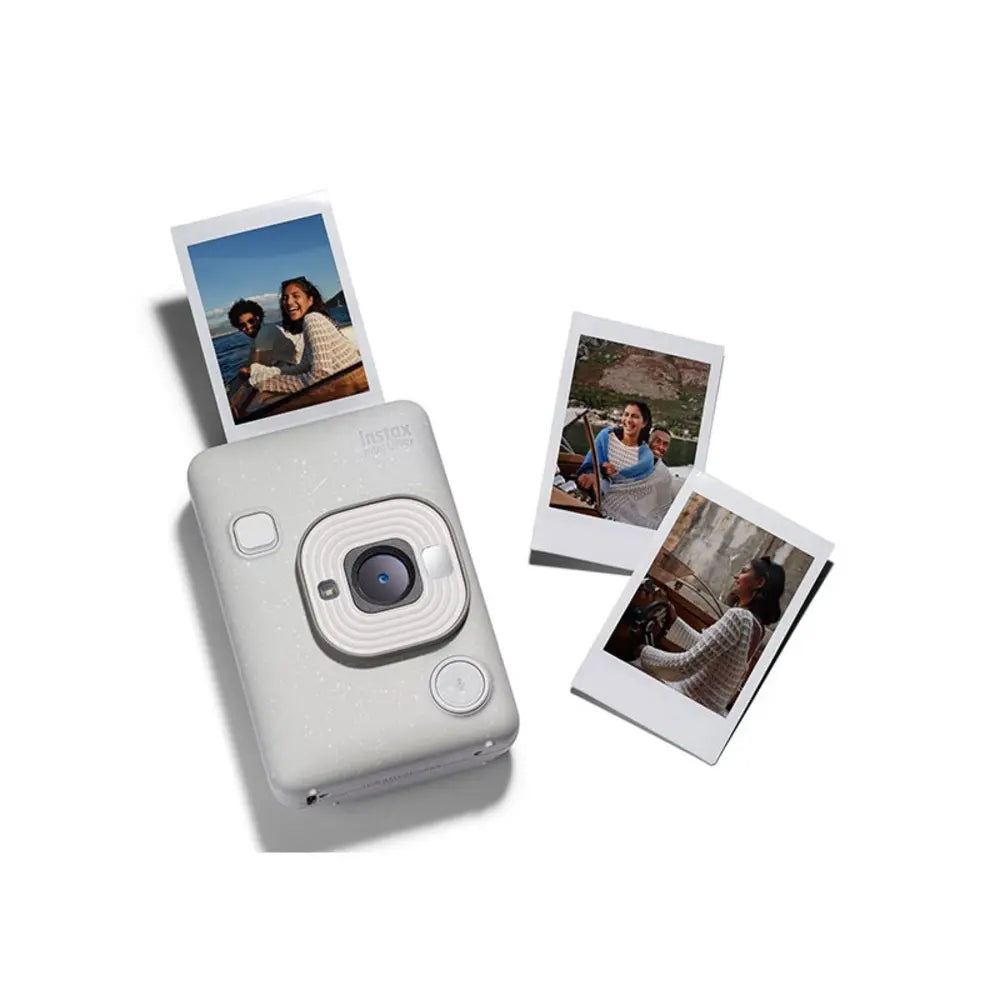 White instant camera with printed photos on a white background