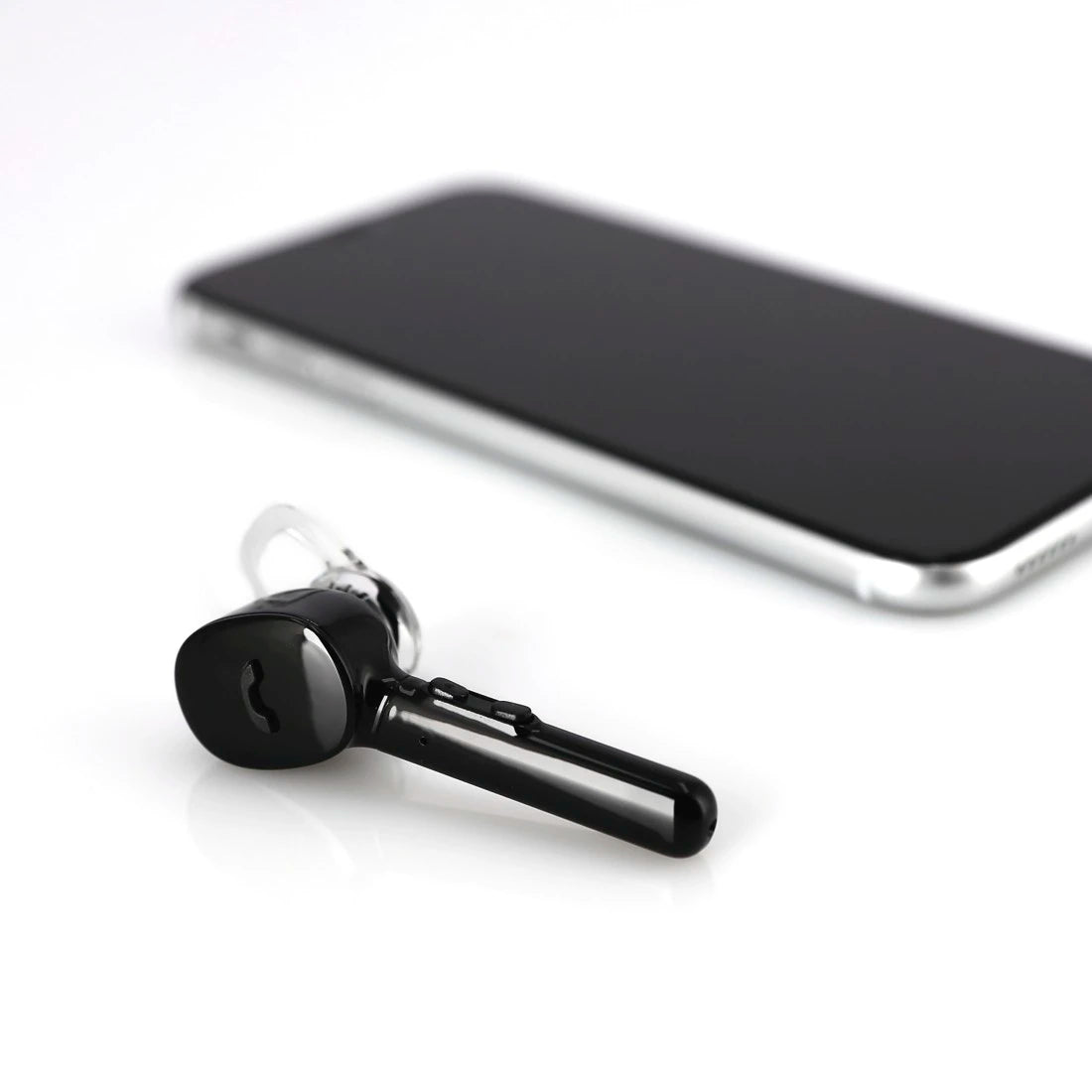 Black wireless earbud with a smartphone on a white background