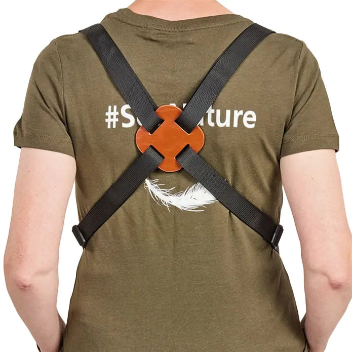 Person wearing a green t-shirt with '#Sustainable' text and a black harness over shoulders.