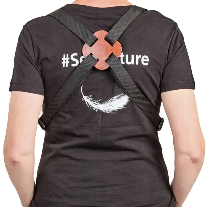 Person wearing a black t-shirt with '#Selfieature' text and a strap over their shoulders.
