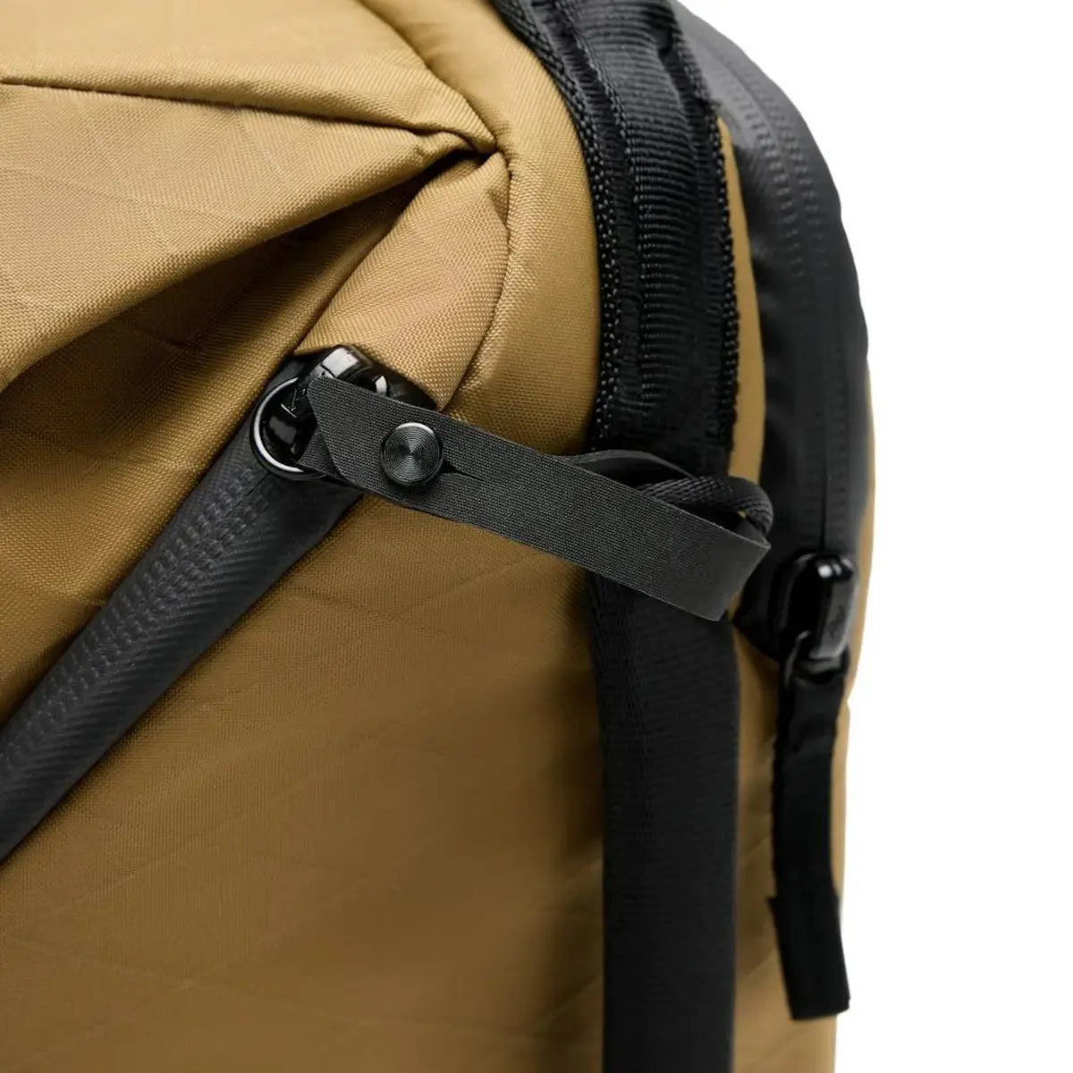 Close-up of a brown backpack with black straps on a white background