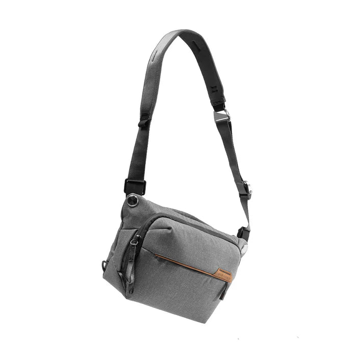 Gray shoulder bag with a strap on a white background