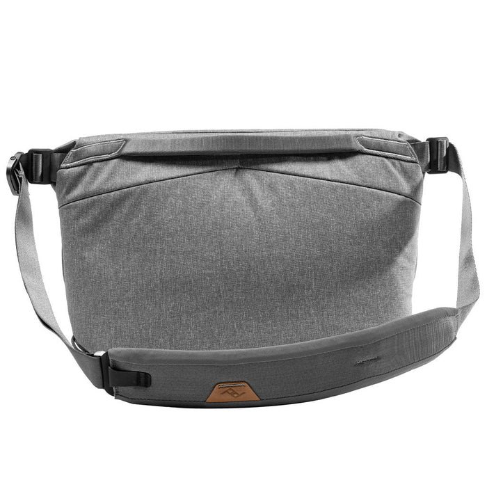 Gray shoulder bag with a strap on a white background