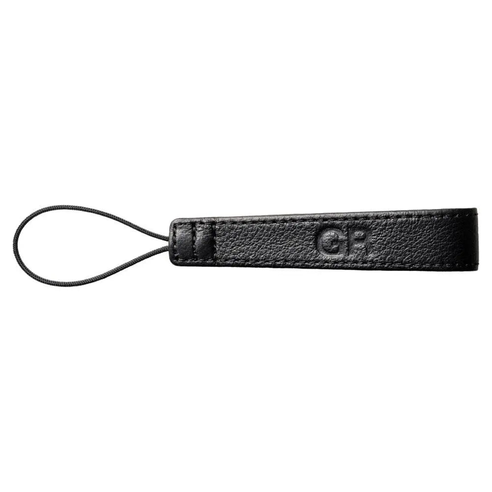 Black leather keychain with 'GP' logo on a white background