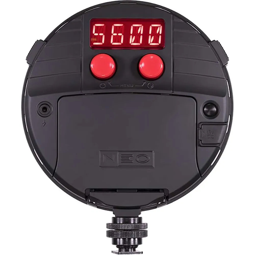 Black circular device with digital display and red buttons on a white background