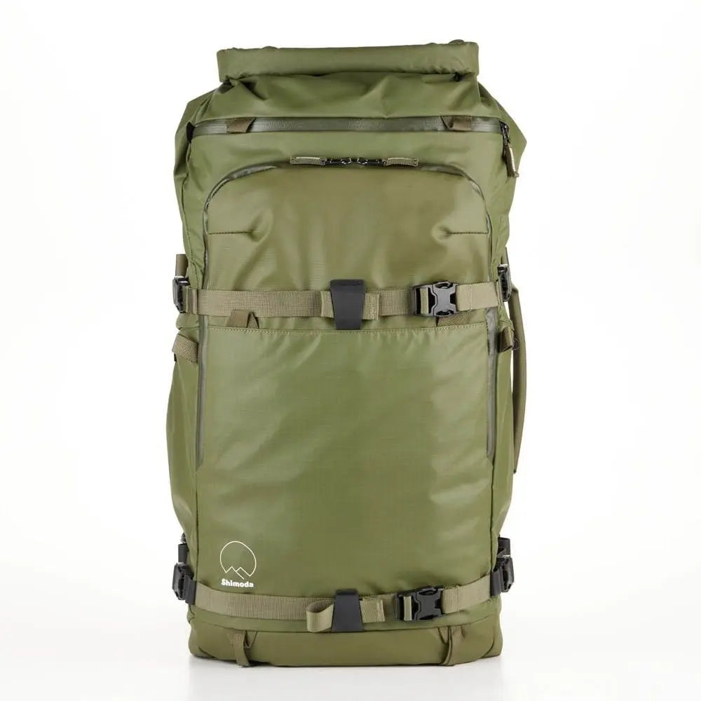 Green backpack with multiple straps on a white background
