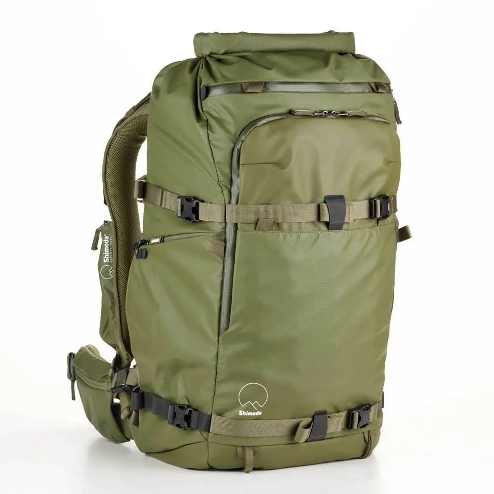 Green backpack with multiple straps on a white background
