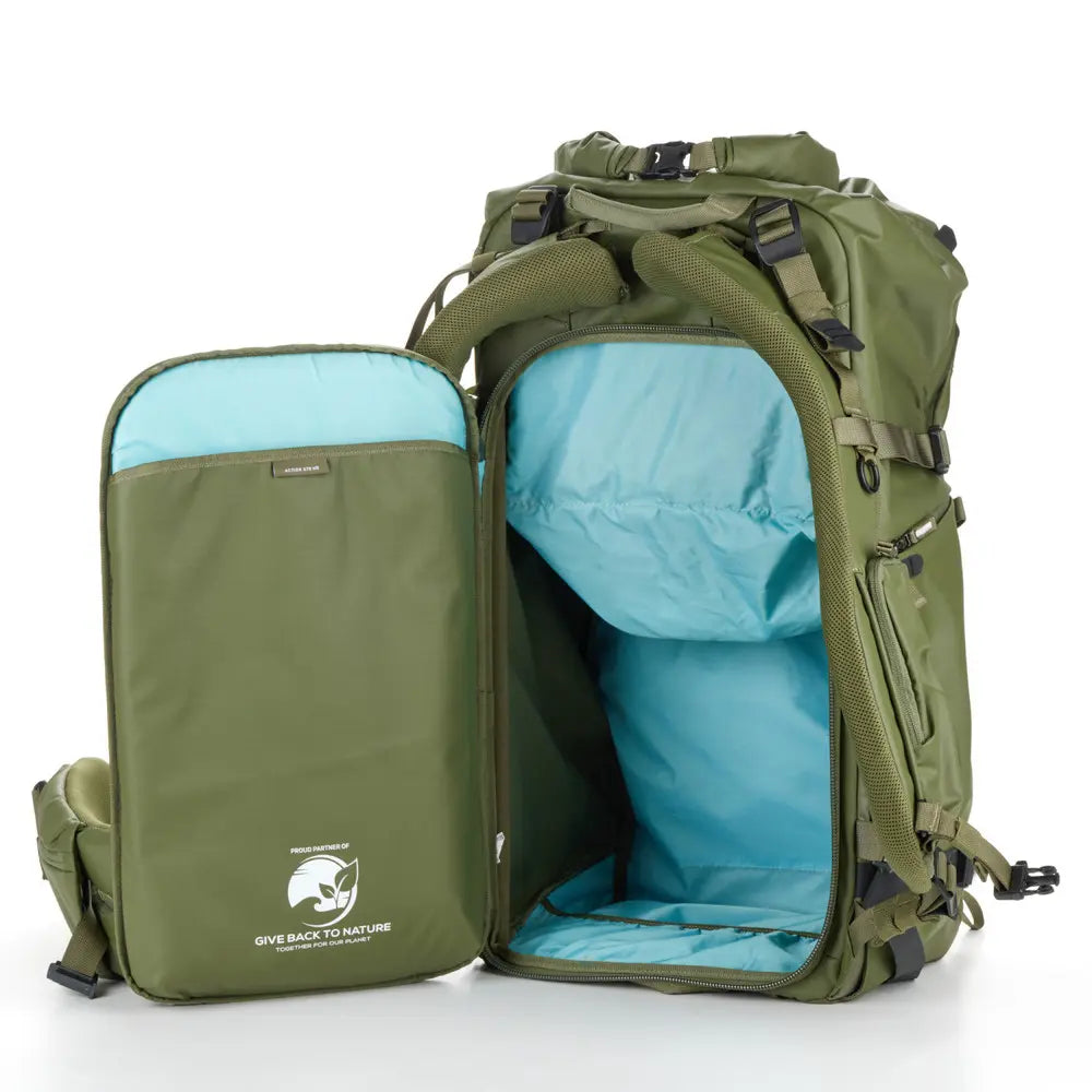 Green backpack with open front compartment revealing a blue interior on a white background