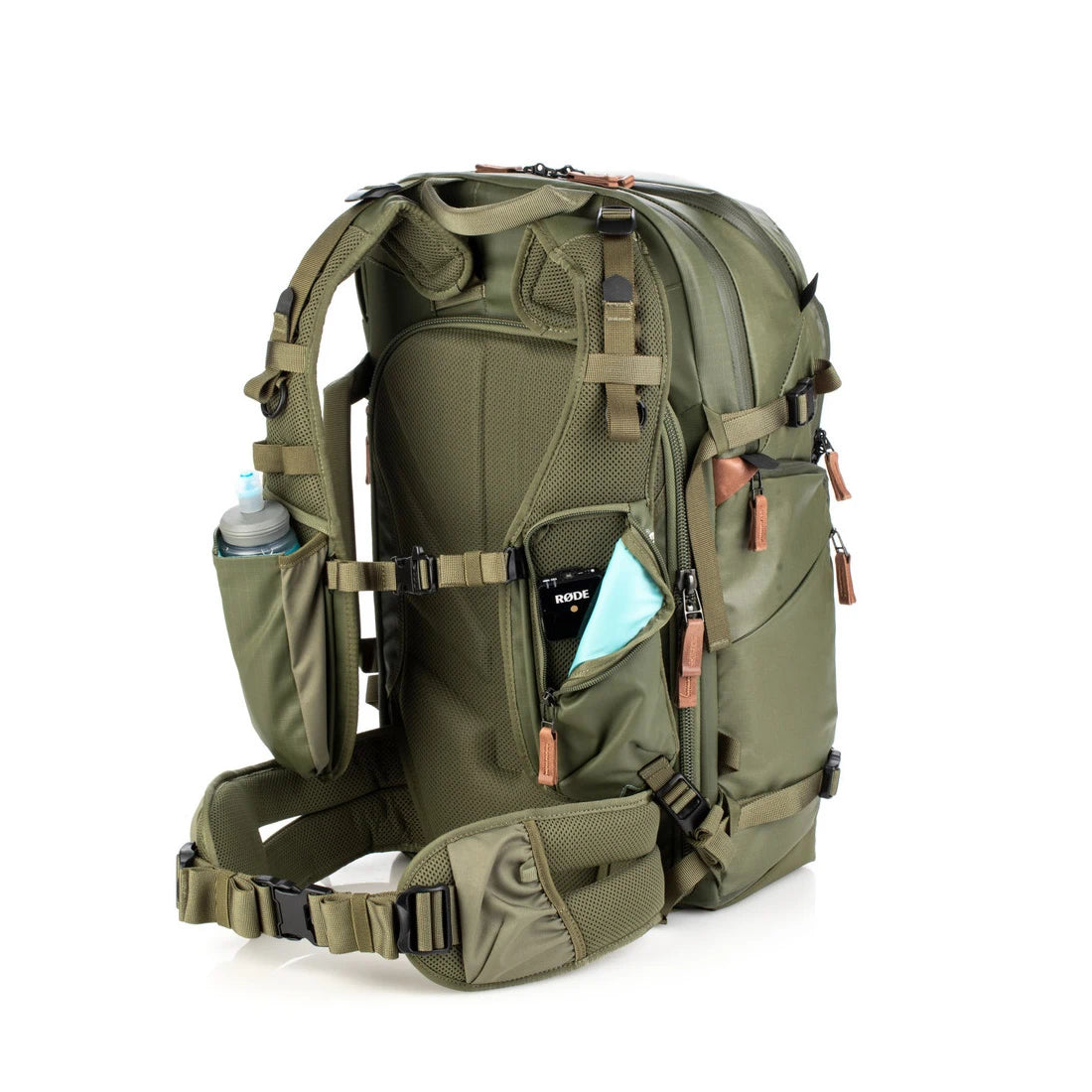 Green tactical backpack with multiple pockets and straps on a white background