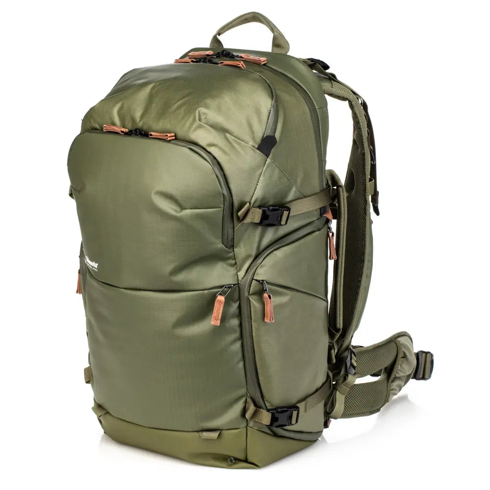 Green backpack with multiple compartments on a white background