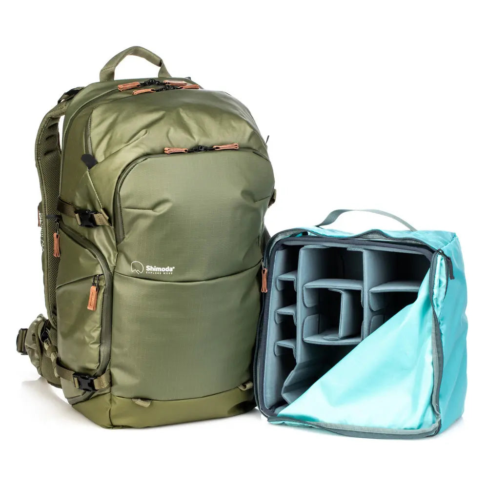 Green backpack with a camera case on a white background