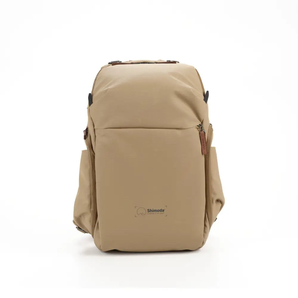 Beige backpack with a visible brand logo on a white background