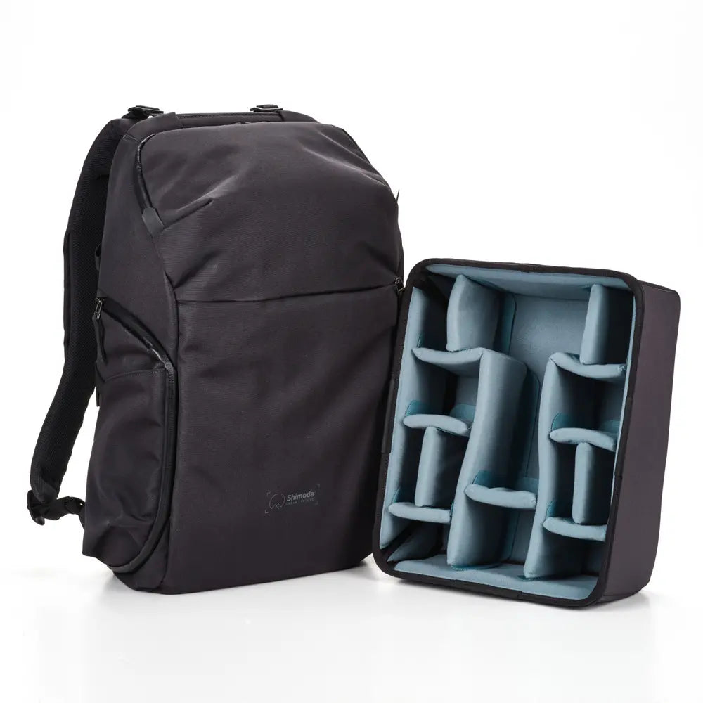 Black backpack with a compartmentalized organizer on a white background