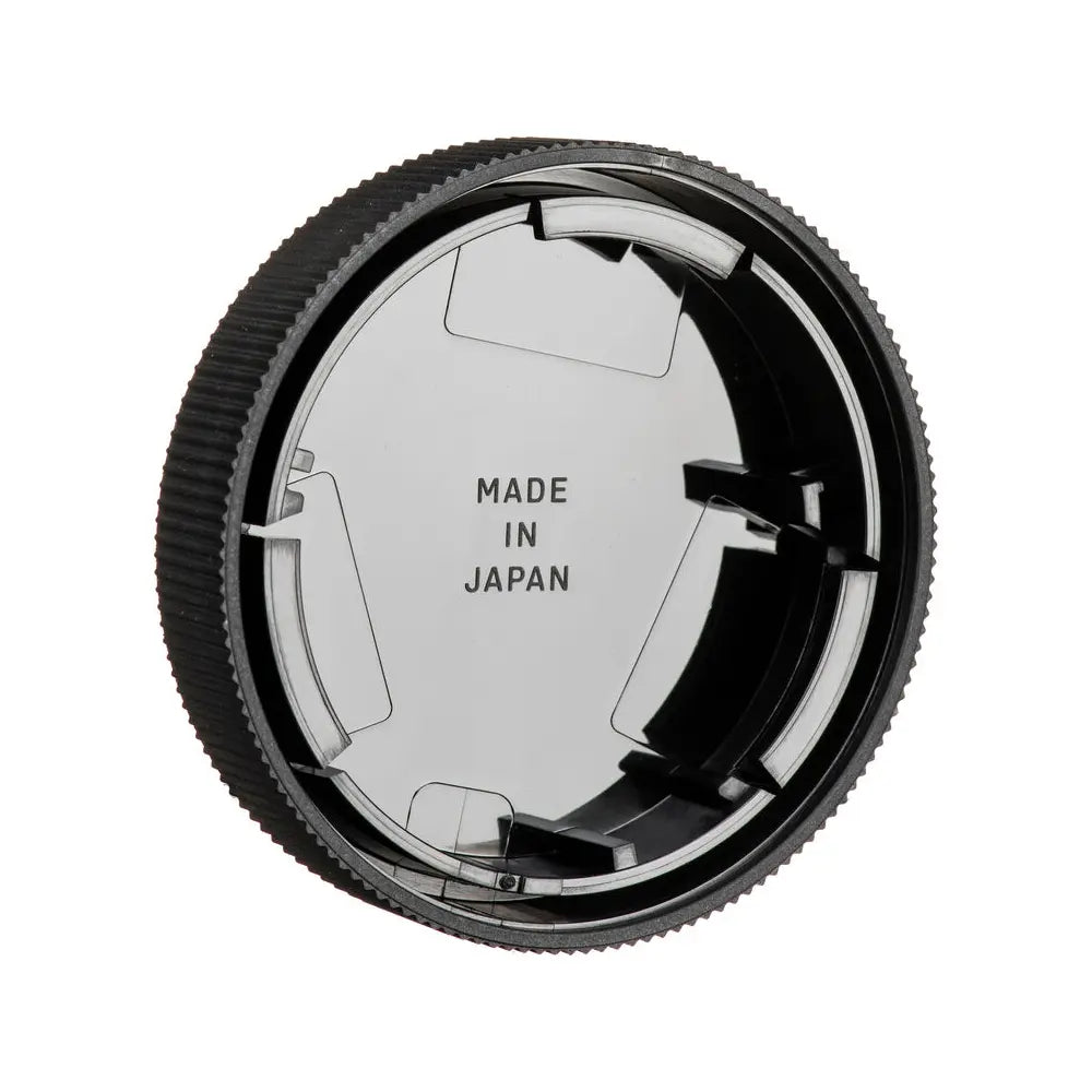 Camera lens cap with 'Made in Japan' text on a white background