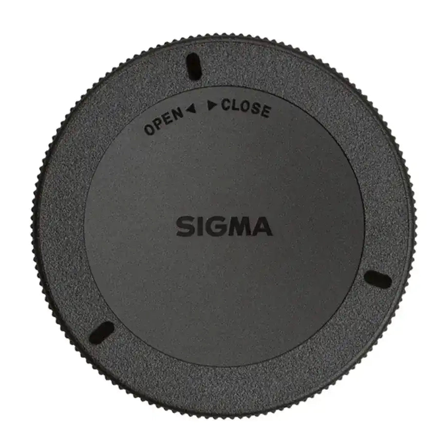 Sigma camera lens cap on a white background